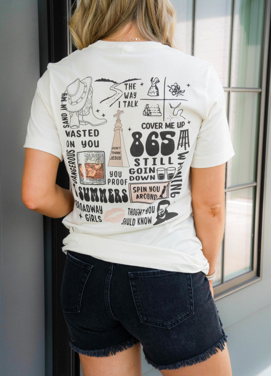 This graphic T-shirt has a white base, a high scooped neck and a longer 3/4 length sleeve.  This tee features a Morgan Wallen graphic with a light pink Texas Longhorn skull in-between “Wal” and “len”. Over the name and skull are 5 light pink stars of varying sizes. The back of the t-shirt  features lyrics from Morgan Wallen's major hits. Runs true to size - Model is wearing a Medium.