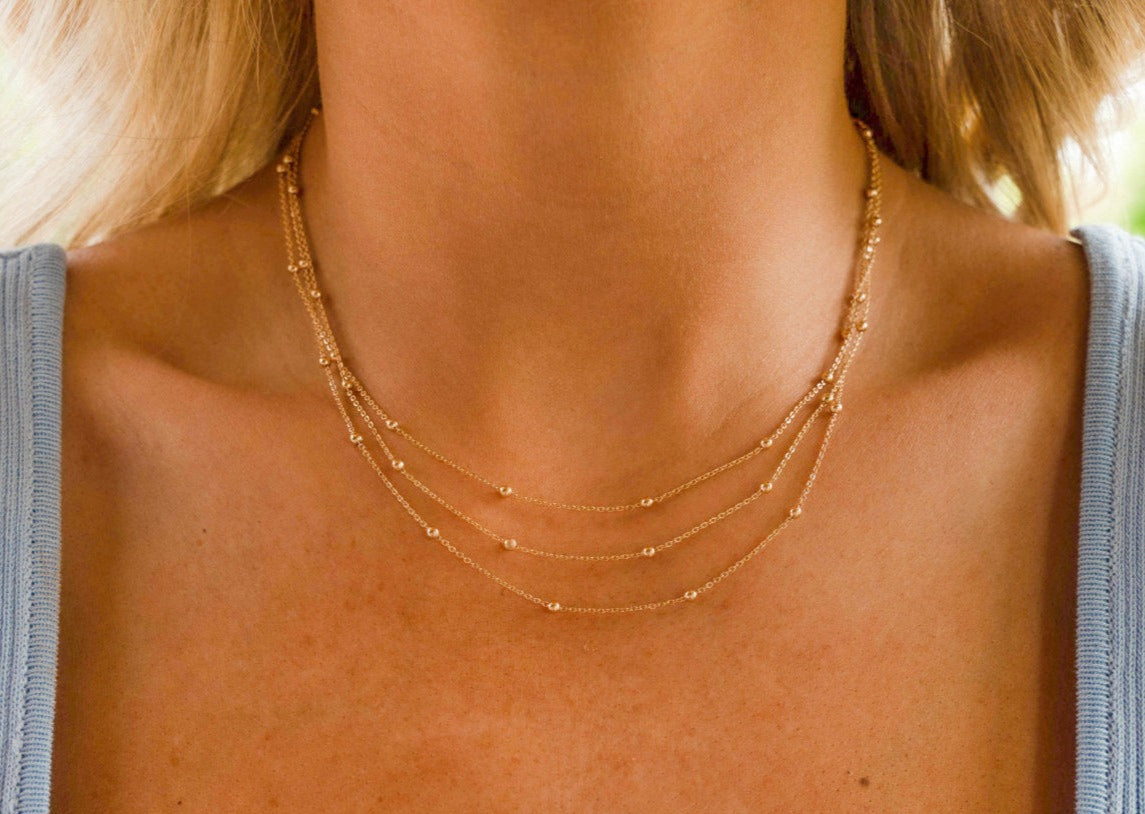 Dainty 3 layered gold beaded necklace.