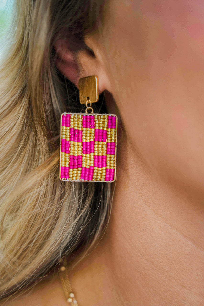 Gold and Hot Pink beaded checkered earrings with a flat gold square stud.